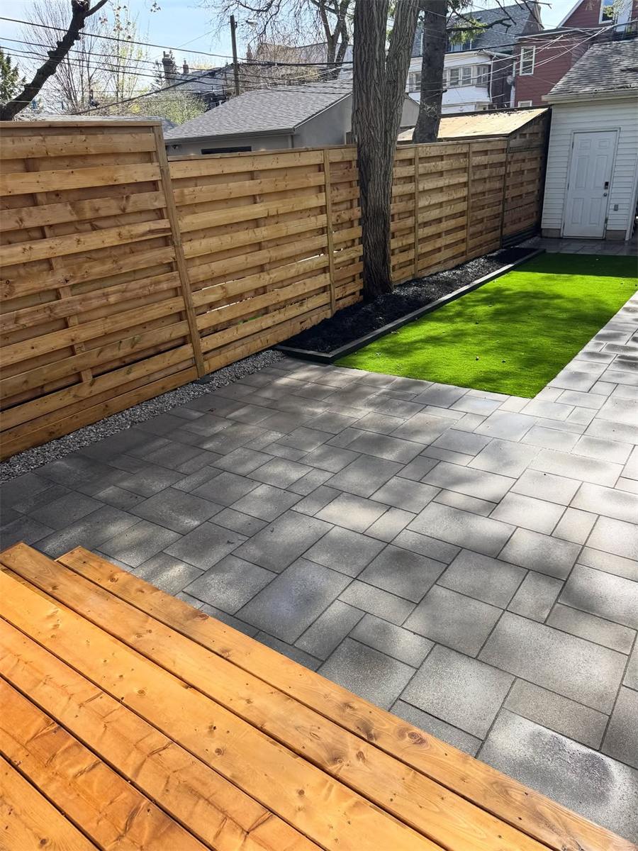 Backyard patio with a new cedar fence and turf