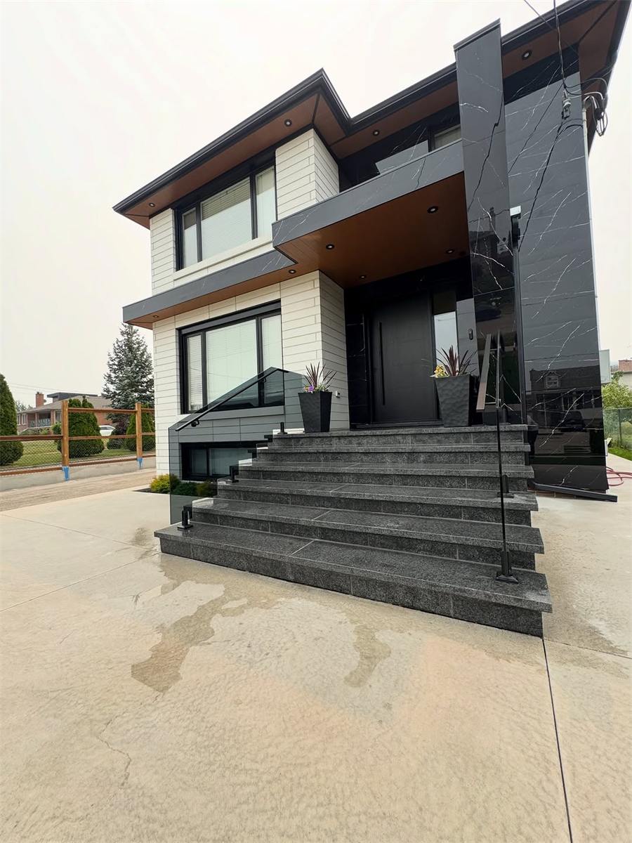Wide granite steps up to a modern home